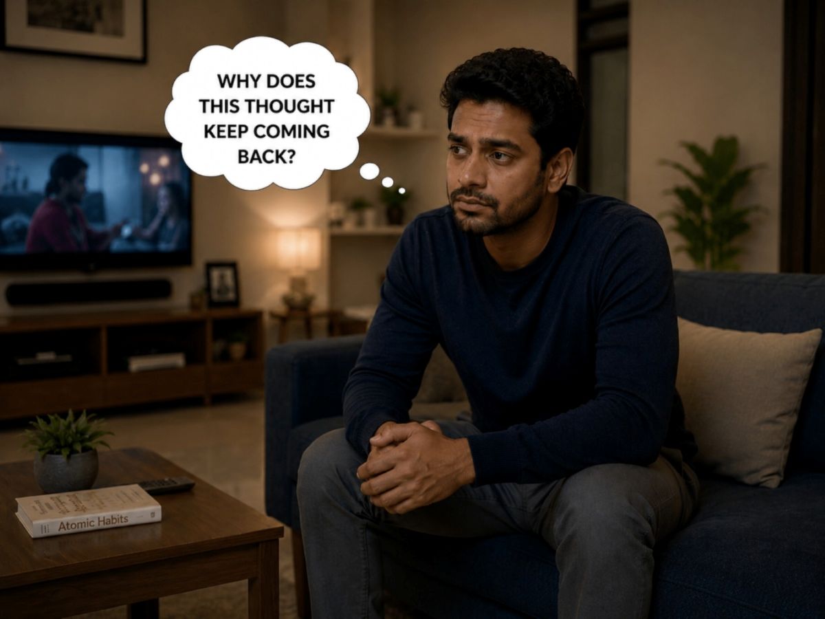 Man on a couch troubled by an unwanted thought that keeps coming back